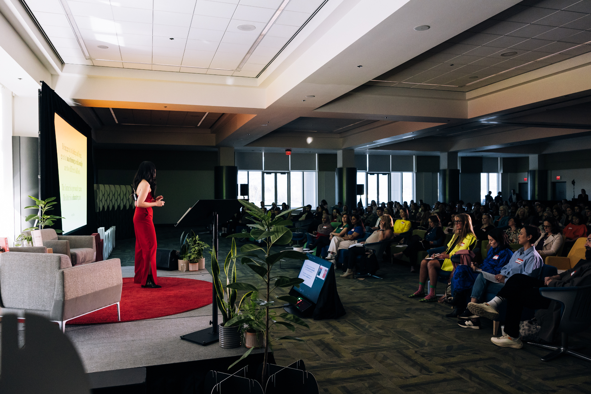 Amy Chan speaking on stage at a TEDx livestream event