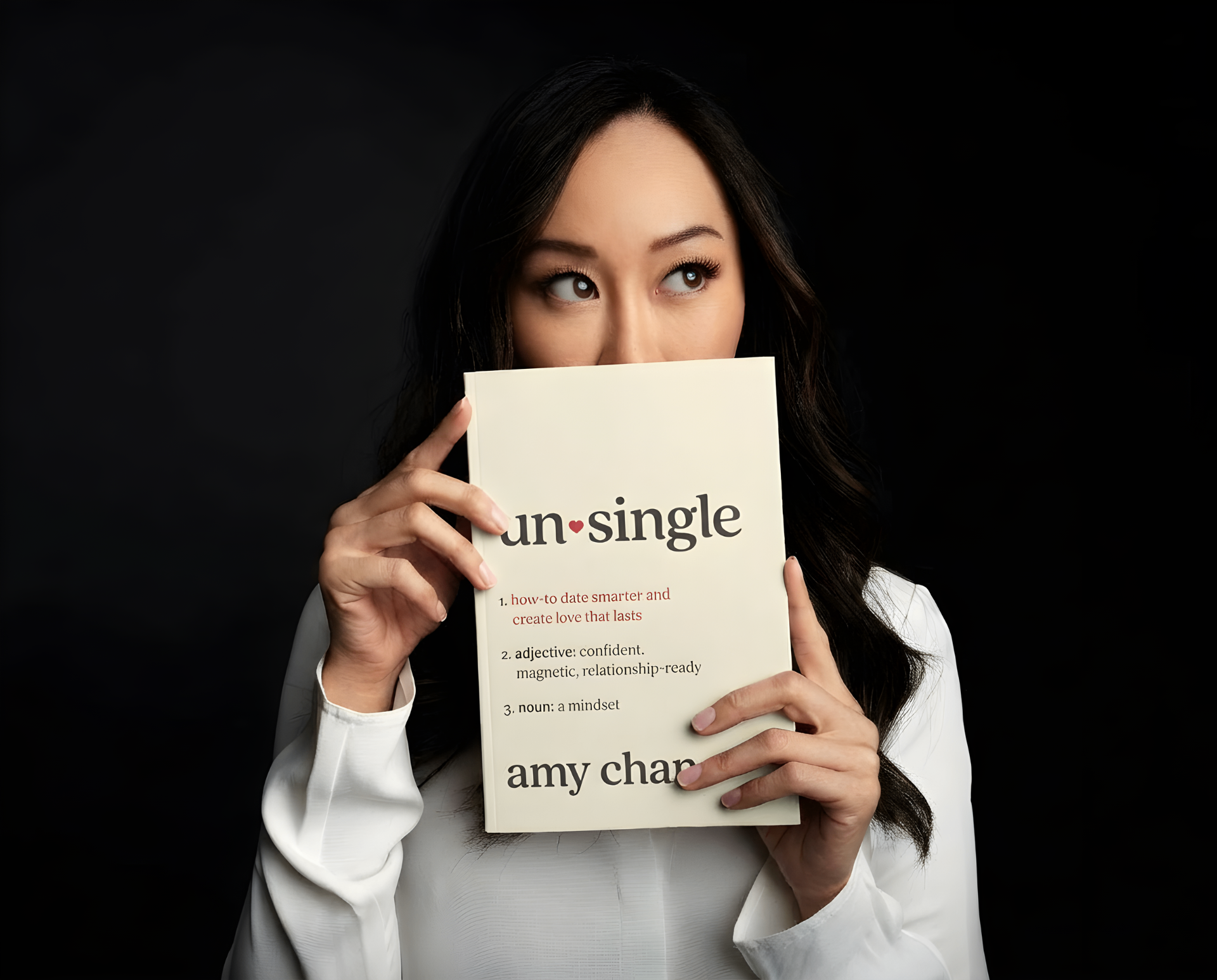 Amy Chan holding her new book Unsingle